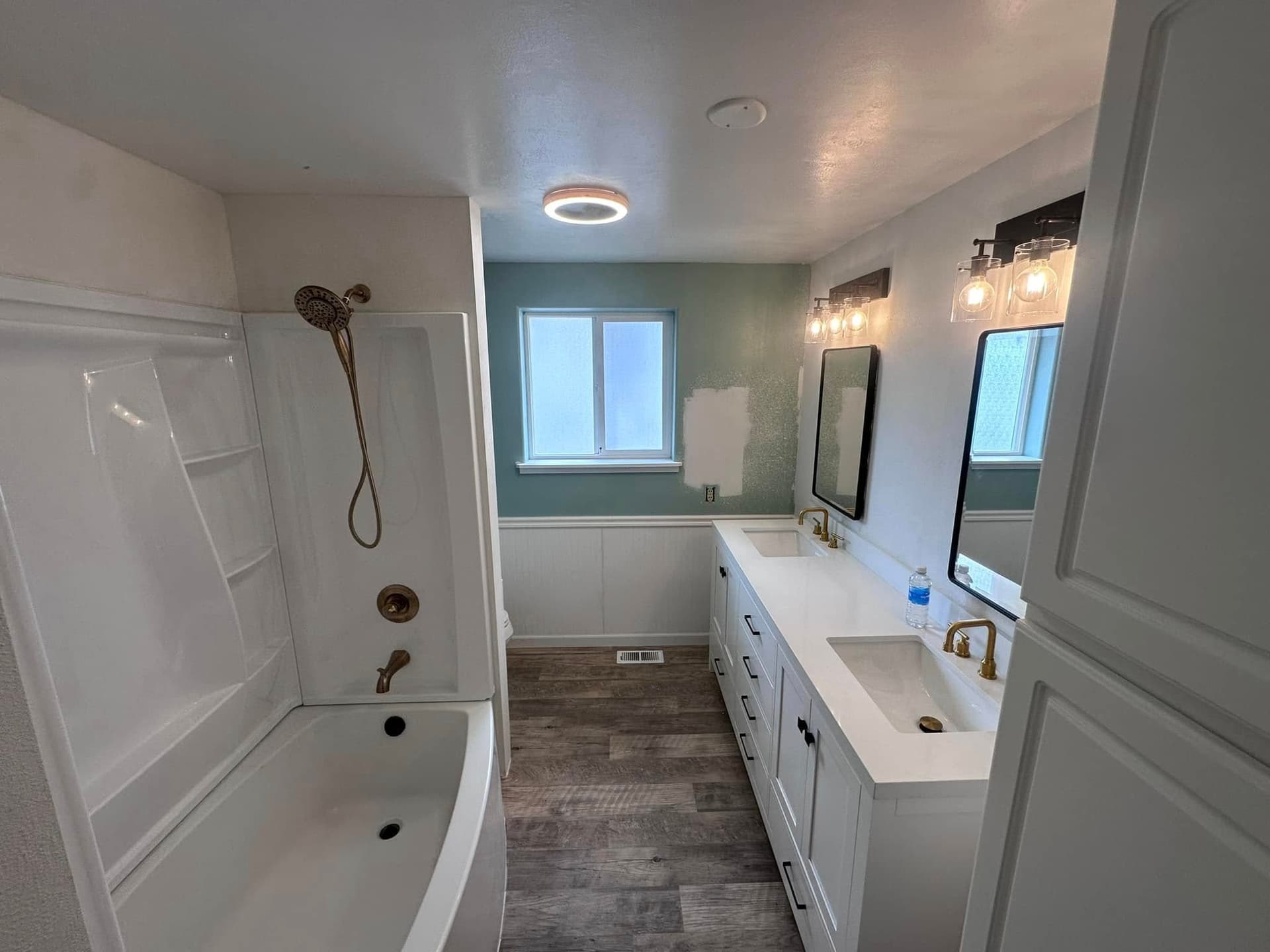 Renovated bathroom with new shower, vanity, and flooring